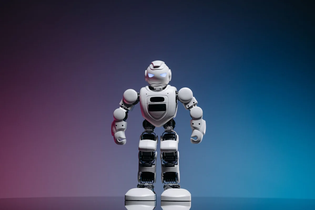 A modern toy robot standing on a gradient background, showcasing innovation and 